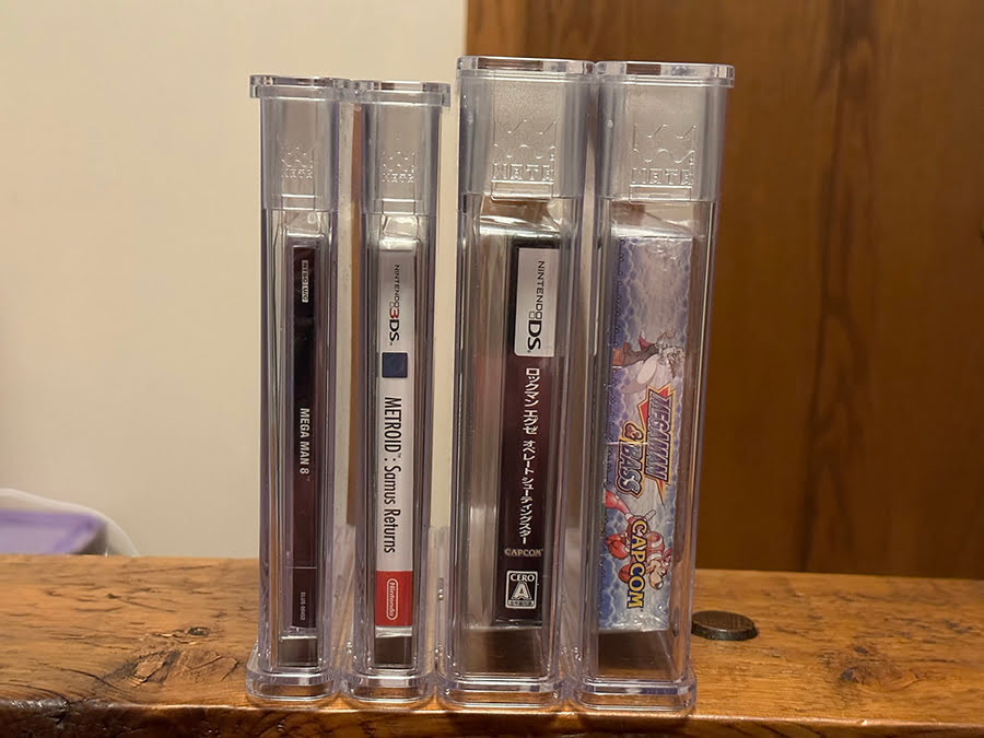 Up close side view showing the same holder size used for PS1 and 3DS, and separately, a shared size for DS and Game Boy.
